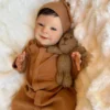 newborn baby doll Sebastian in brown dress